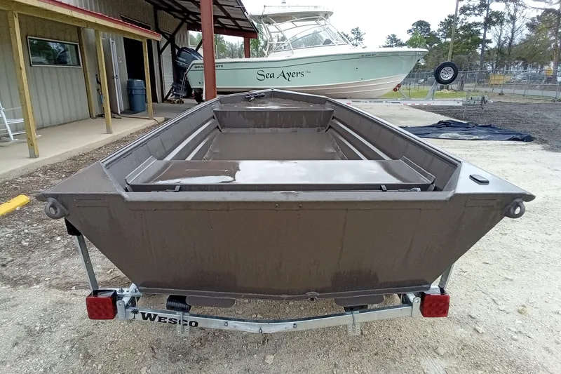 Slide: The Image of 2025 Alweld 1548VV Marsh boat on trailer, parked outdoors near a building. - 9