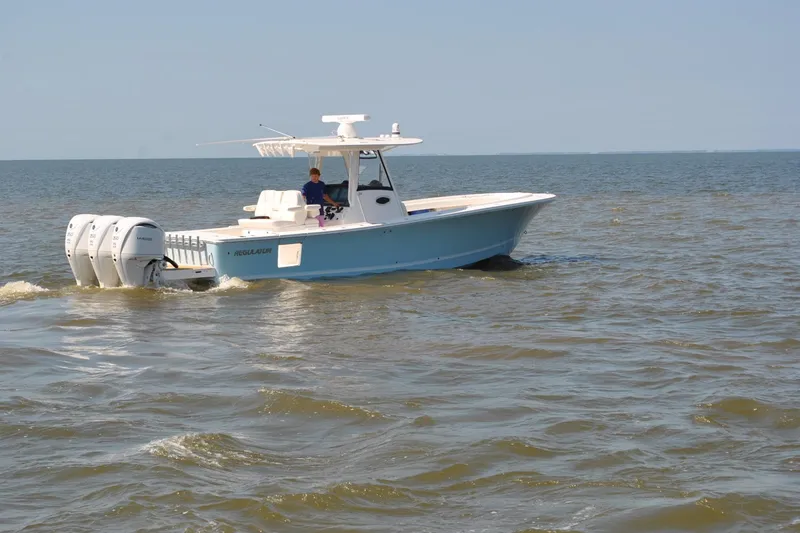 Slide: The Image of 2025 Regulator 34 Center Console boat cruising on open water. - 10