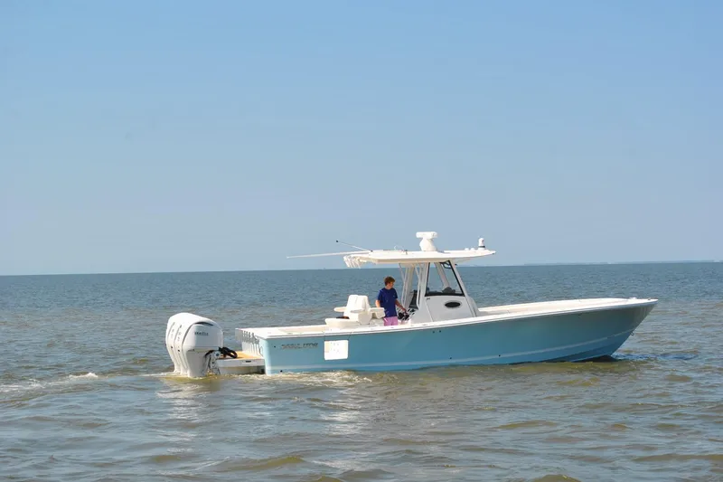 Slide: The Image of 2025 Regulator 34 Center Console boat cruising on open water. - 11