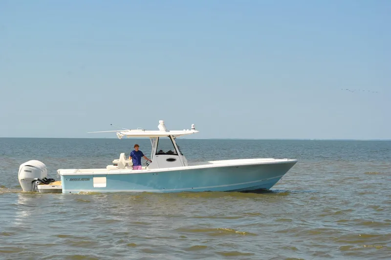 Slide: The Image of 2025 Regulator 34 Center Console boat cruising on open water. - 12