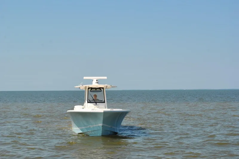Slide: The Image of 2025 Regulator 34 Center Console boat on open water under clear sky. - 16