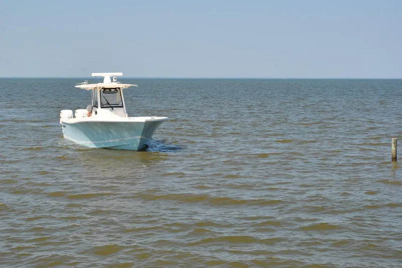 Slide: The Image of 2025 Regulator 34 Center Console boat cruising on open water. - 17