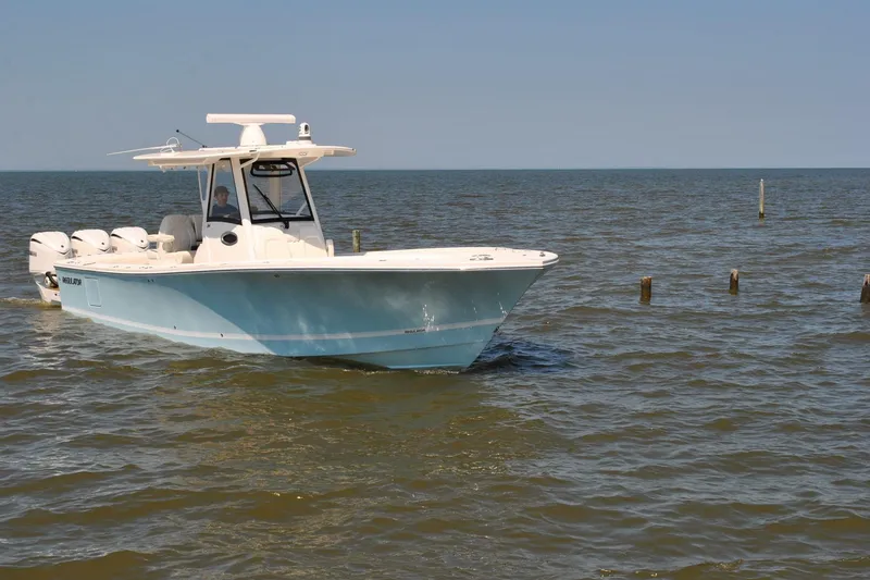 Slide: The Image of 2025 Regulator 34 Center Console boat cruising on open water. - 18