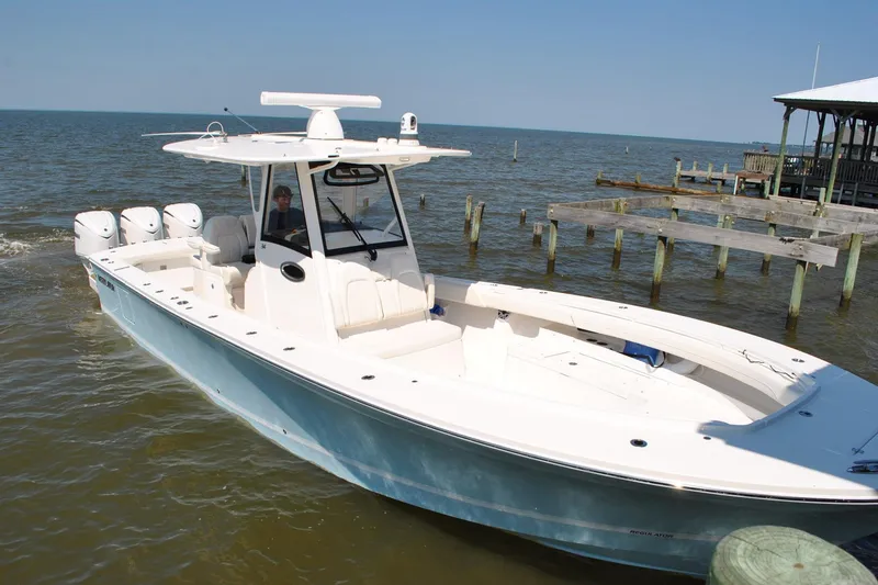 Slide: The Image of 2025 Regulator 34 Center Console boat docked by the pier on a sunny day. - 25