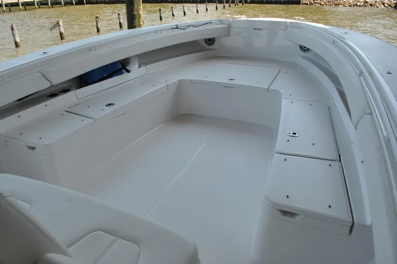 Slide: The Image of 2025 Regulator 34 Center Console boat interior with spacious seating and storage compartments. - 26
