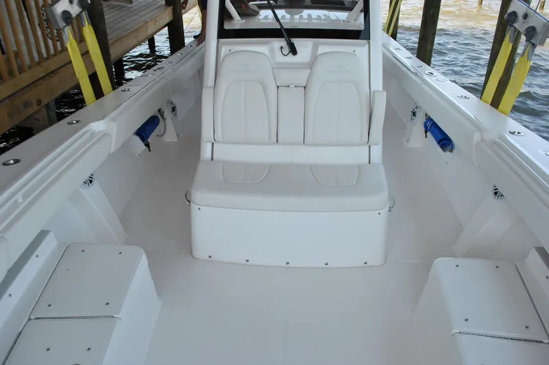 Slide: The Image of 2025 Regulator 34 Center Console boat interior with white seating and spacious deck. - 27