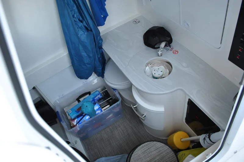 Slide: The Image of 2025 Regulator 34 Center Console interior with storage, sink, and organized supplies. - 28