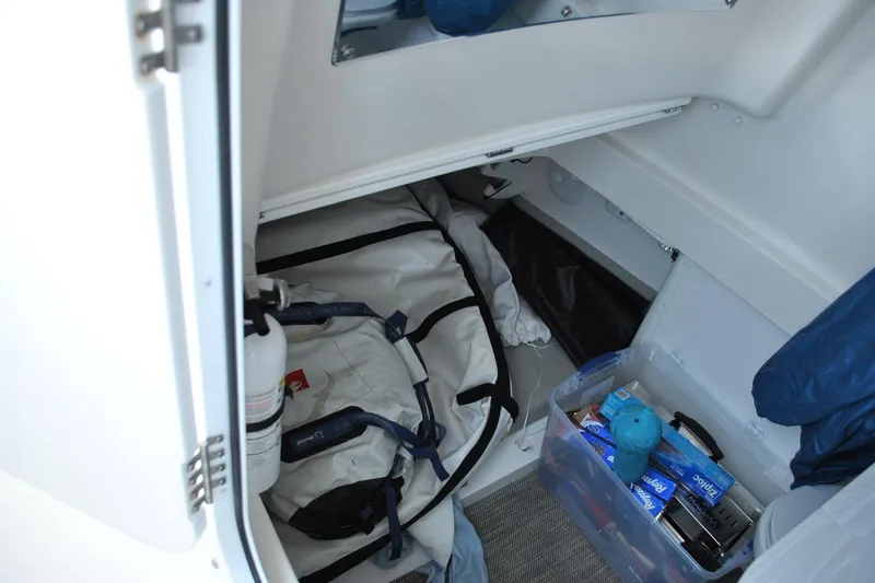 Slide: The Image of 2025 Regulator 34 Center Console storage area with safety equipment and supplies. - 29