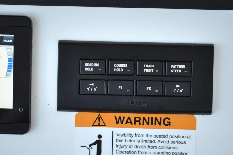 Slide: The Image of Control panel on 2025 Regulator 34 Center Console with navigation and warning labels. - 31