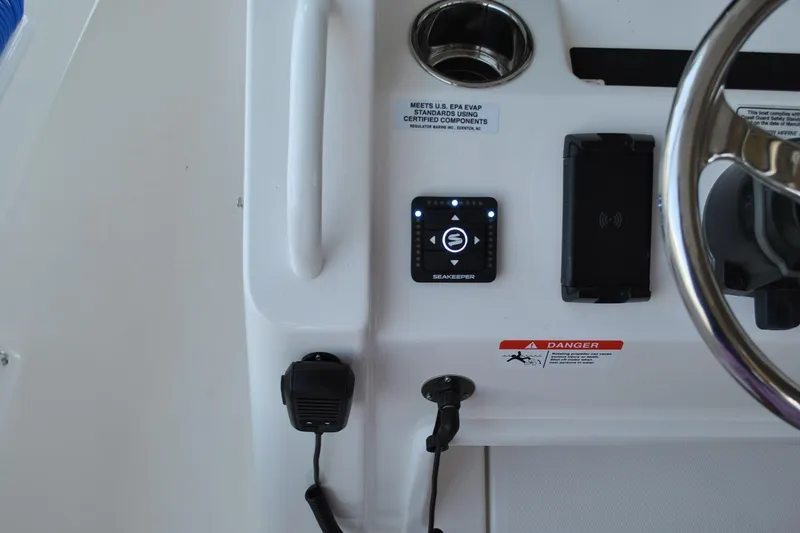 Slide: The Image of 2025 Regulator 34 Center Console dashboard with Seakeeper control and steering wheel. - 43