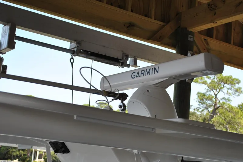 Slide: The Image of 2025 Regulator 34 Center Console with Garmin radar system under wooden shelter. - 45