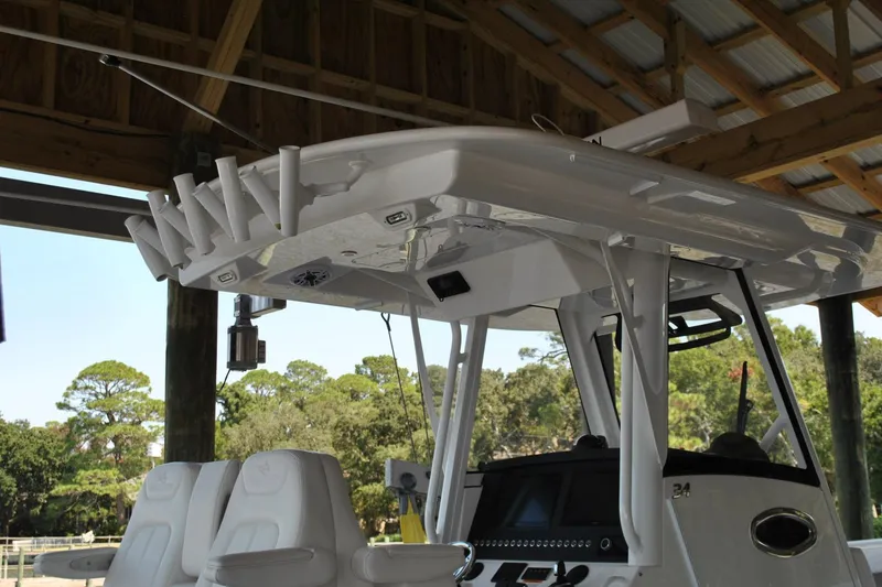 Slide: The Image of 2025 Regulator 34 Center Console boat interior with seating and control panel under a canopy. - 50