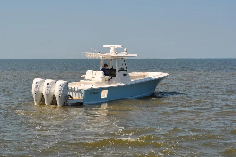 Slide: The Image of 2025 Regulator 34 Center Console boat cruising on open water. - 9