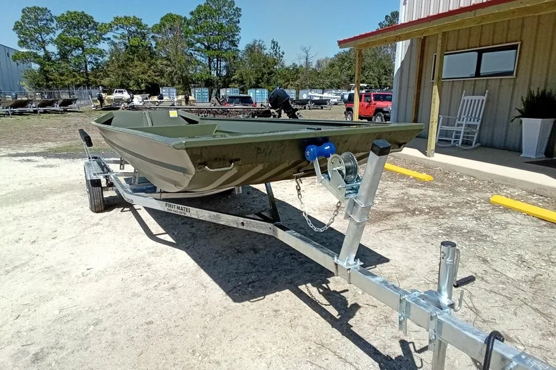 Slide: The Image of 2025 Alweld 1542 Flat Marsh boat on trailer, parked outdoors near a building. - 5