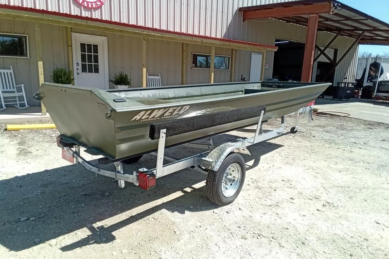 Slide: The Image of 2025 Alweld 1542 Flat Marsh boat on trailer outside a building. - 9