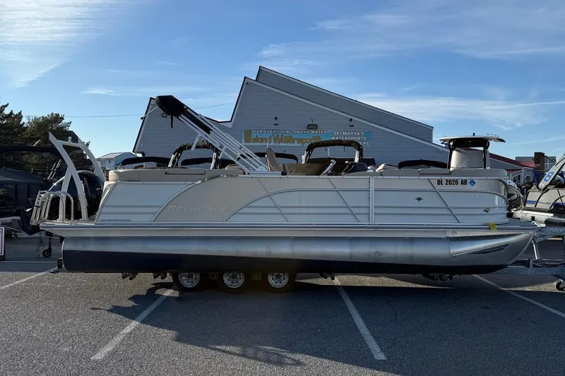 The Image of 2026 Berkshire 23RFX STS pontoon boat parked outdoors in a marina setting. - 26