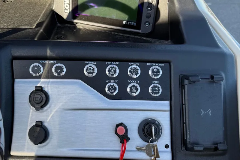 Slide: The Image of Control panel of 2026 Berkshire 23RFX STS boat with various switches and a Lowrance Elite display. - 38