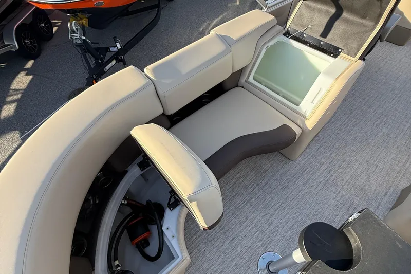 Slide: The Image of 2026 Berkshire 23RFX STS boat interior with beige seating and storage compartments. - 39