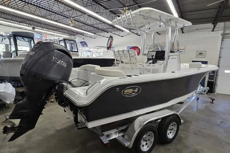 Slide: The Image of 2026 Sea Hunt Ultra 219 boat with Yamaha engine in showroom. - 10