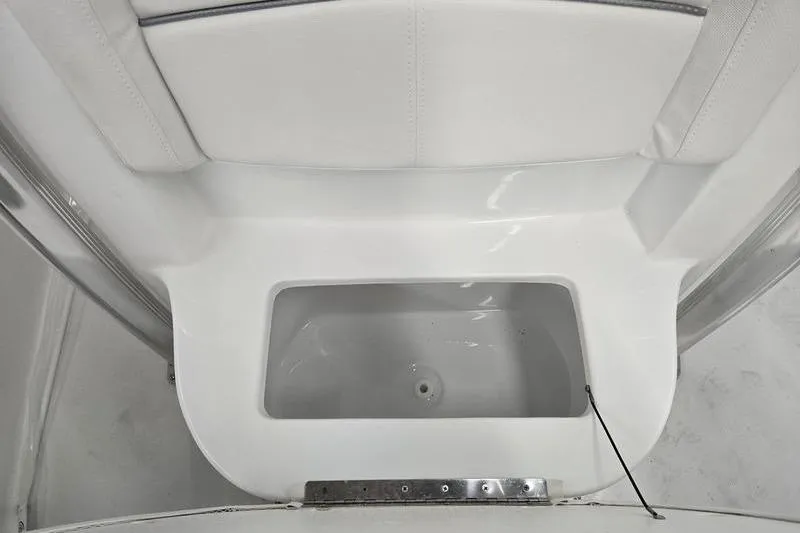 Slide: The Image of 2026 Sea Hunt Ultra 219 boat interior, featuring a white storage compartment. - 12