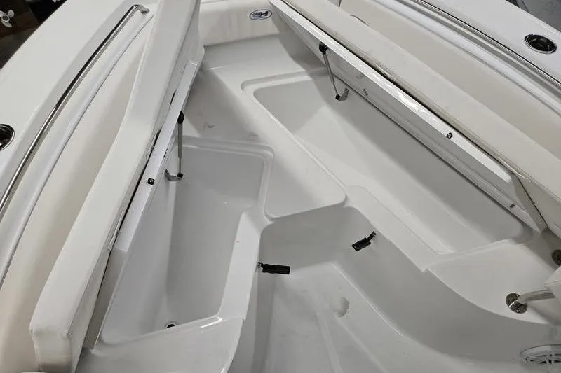 Slide: The Image of Interior view of 2026 Sea Hunt Ultra 219 boat, showcasing seating and storage compartments. - 19