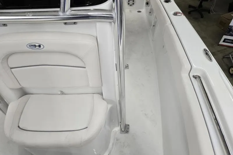 Slide: The Image of 2026 Sea Hunt Ultra 219 boat interior with white seating and stainless steel railing. - 20