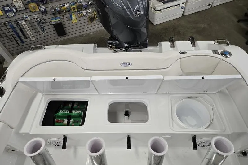 Slide: The Image of 2026 Sea Hunt Ultra 219 boat interior with storage compartments and fishing rod holders. - 4