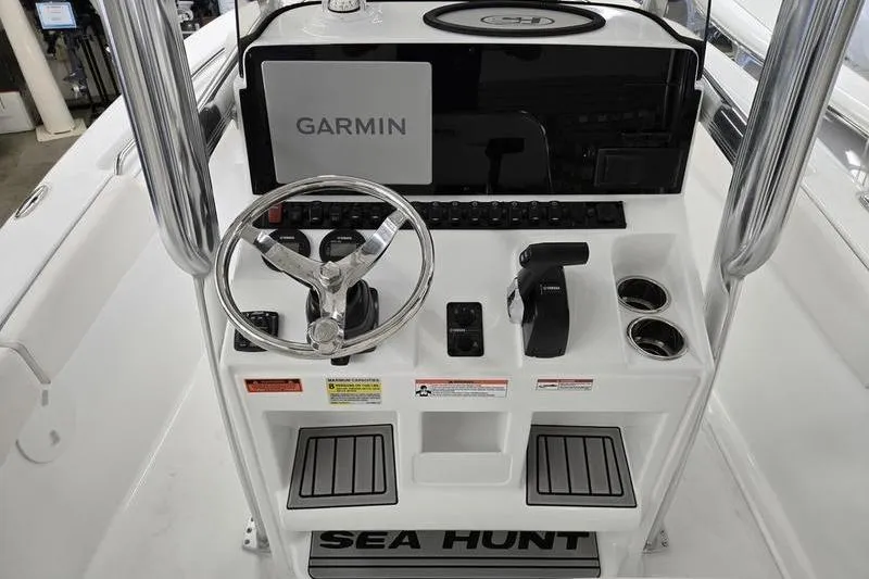 Slide: The Image of 2026 Sea Hunt Ultra 219 boat console with Garmin navigation system and steering wheel. - 6