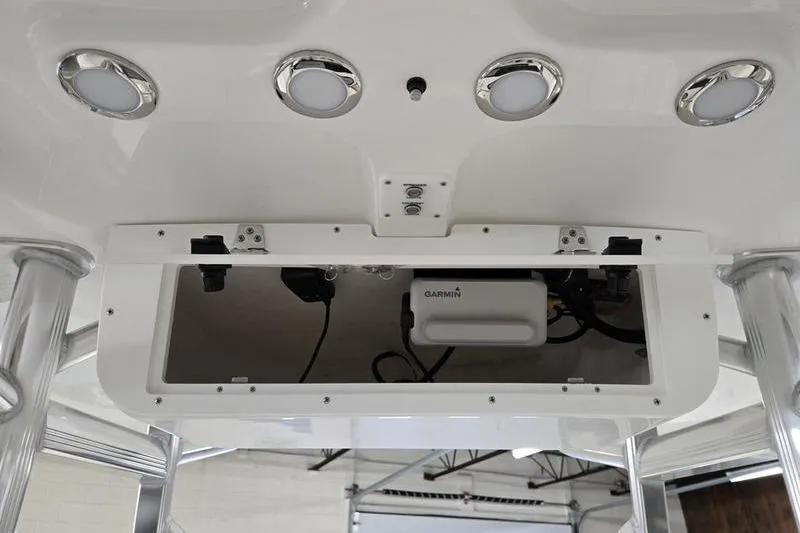 Slide: The Image of 2026 Sea Hunt Ultra 219 boat electronics compartment with Garmin device and LED lights. - 7