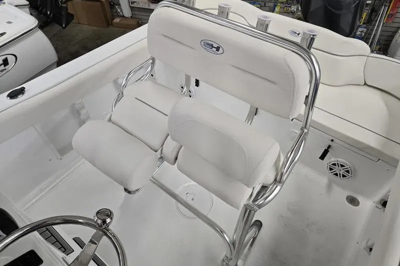 Slide: The Image of 2026 Sea Hunt Ultra 219 boat interior with white seating and chrome accents. - 9