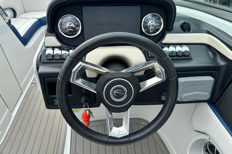 Slide: The Image of 2021 Crownline Eclipse E235 SURF boat dashboard with steering wheel and controls. - 10