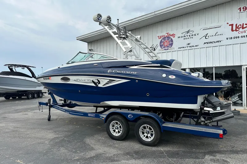 Slide: The Image of 2021 Crownline Eclipse E235 SURF boat on trailer outside dealership. - 2