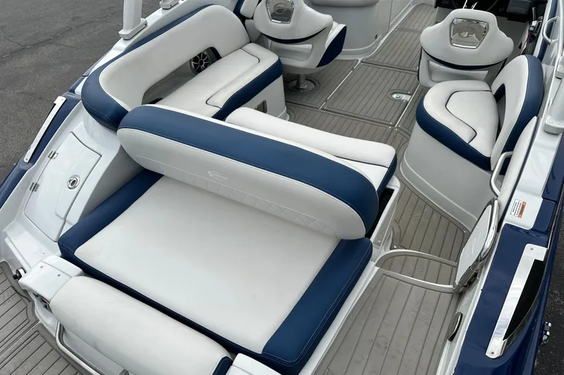 Slide: The Image of 2021 Crownline Eclipse E235 SURF boat interior with blue and white seating. - 4