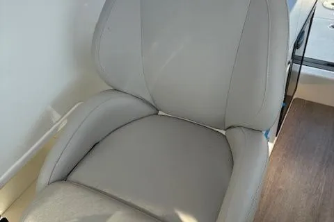 Slide: The Image of 2024 Bayliner Trophy T25 Explorer boat seat, gray upholstery, interior view. - 11