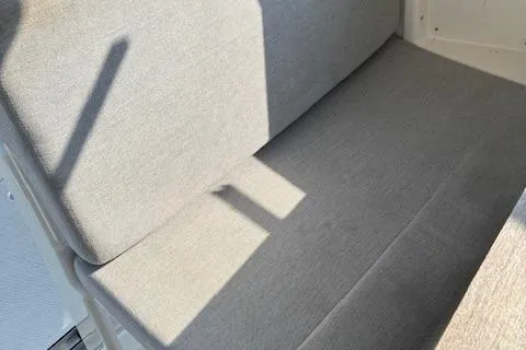 Slide: The Image of 2024 Bayliner Trophy T25 Explorer interior seating with gray upholstery. - 13