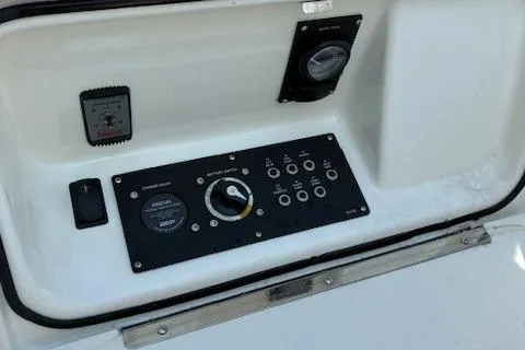 Slide: The Image of 2024 Bayliner Trophy T25 Explorer control panel with switches and gauges. - 15
