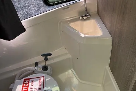 Slide: The Image of 2024 Bayliner Trophy T25 Explorer boat interior with sink and toilet. - 19
