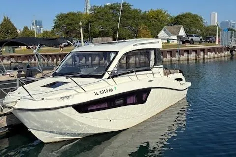 Slide: The Image of 2024 Bayliner Trophy T25 Explorer docked at marina, showcasing sleek design and modern features. - 2