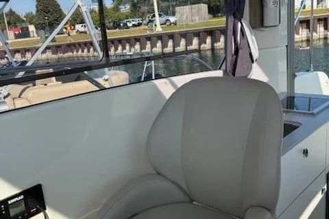 Slide: The Image of 2024 Bayliner Trophy T25 Explorer boat interior with comfortable seating and modern design. - 22