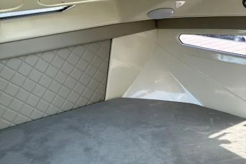 Slide: The Image of 2024 Bayliner Trophy T25 Explorer cabin interior with quilted paneling and sleek design. - 23