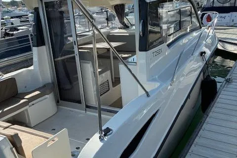 Slide: The Image of 2024 Bayliner Trophy T25 Explorer boat docked, showcasing sleek design and spacious interior. - 6