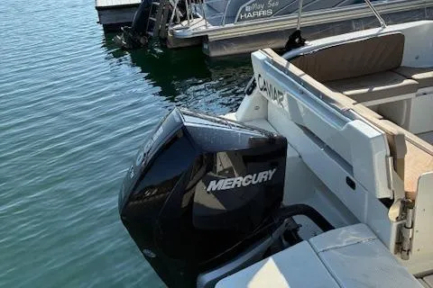 Slide: The Image of 2024 Bayliner Trophy T25 Explorer with Mercury outboard engine docked on calm water. - 7