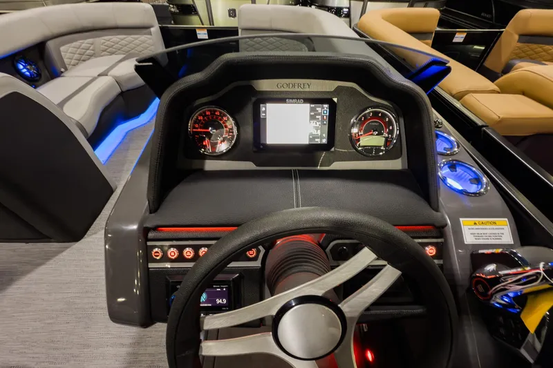 Slide: The Image of Steering console of 2026 Godfrey Monaco 235 Split Bench pontoon boat with illuminated controls. - 10