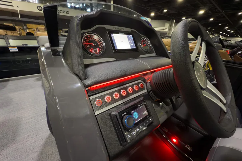 Slide: The Image of 2026 Godfrey Monaco 235 Split Bench dashboard with illuminated controls and steering wheel. - 11