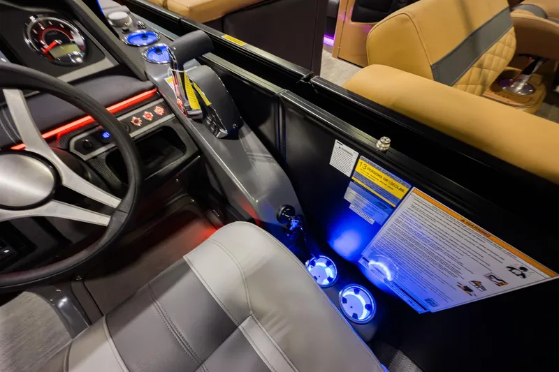Slide: The Image of 2026 Godfrey Monaco 235 Split Bench interior with illuminated cup holders and modern dashboard. - 13