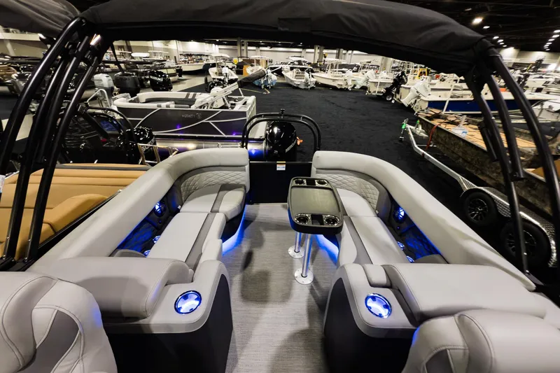 Slide: The Image of 2026 Godfrey Monaco 235 Split Bench boat interior with modern seating and ambient lighting. - 16