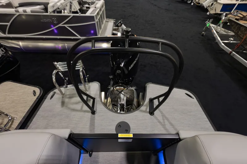 Slide: The Image of 2026 Godfrey Monaco 235 Split Bench boat interior with motor and seating area. - 18