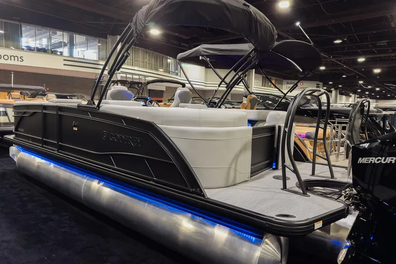 Slide: The Image of 2026 Godfrey Monaco 235 Split Bench pontoon boat displayed indoors with blue LED lighting. - 2