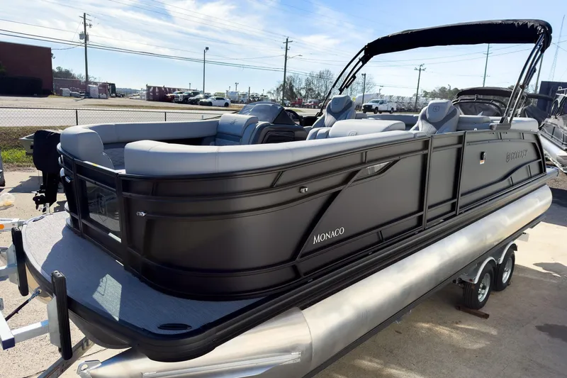 Slide: The Image of 2026 Godfrey Monaco 235 Split Bench pontoon boat on trailer, sleek black design. - 25