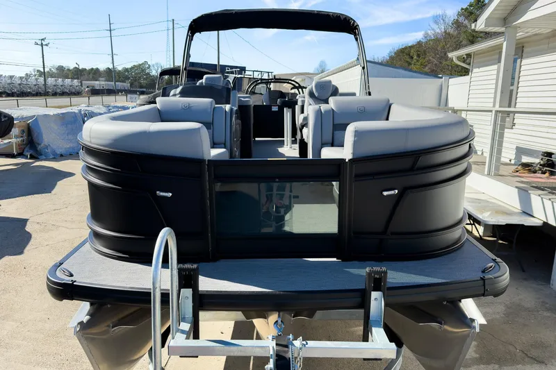 Slide: The Image of 2026 Godfrey Monaco 235 Split Bench pontoon boat, black exterior, docked outdoors. - 26